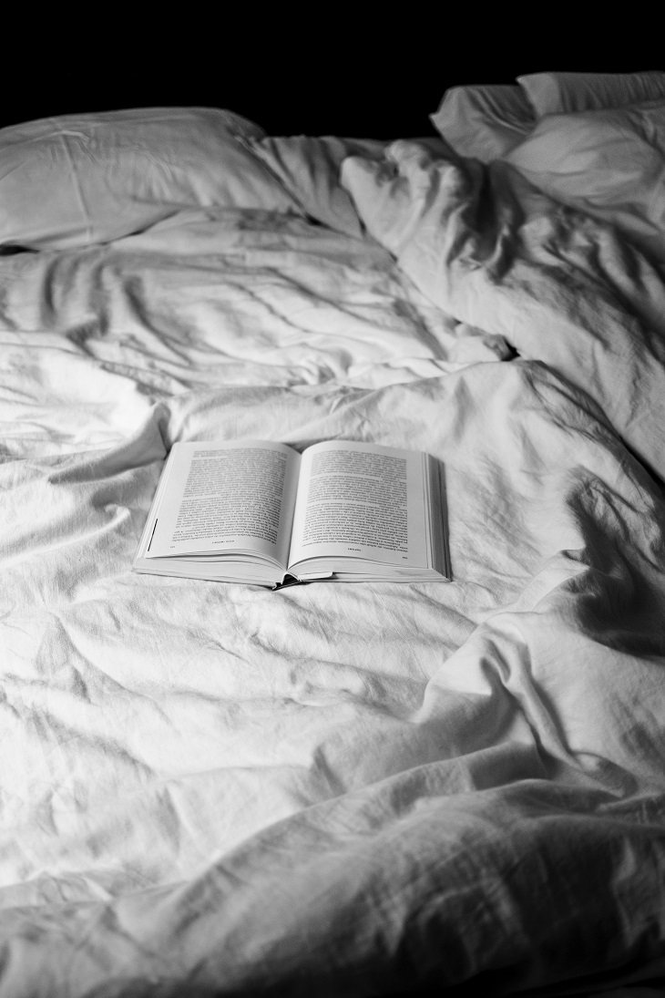 Photo of book on a bed, reading before bed is an important Sleep Tip for Athletes